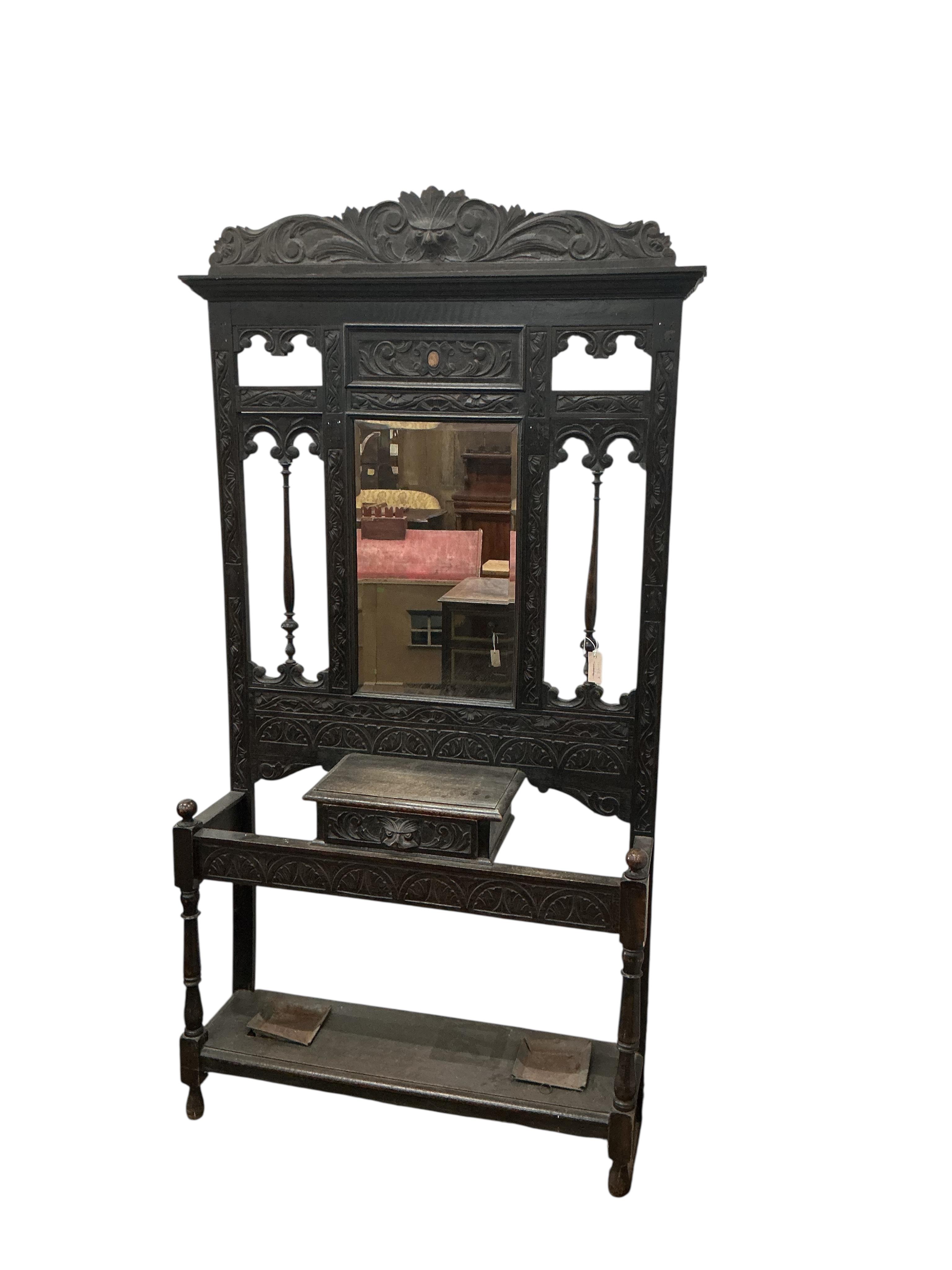 A late Victorian carved oak hallstand, width 108cm, height 210cm